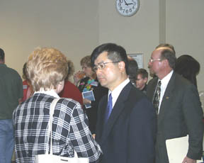 Gov. Gary Locke talks with people following the 2002 Workers Memorial Day at Labor and Industries headquarters in Tumwater. Locke was one of several speakers at the event commemorating workers who died in Washington state in 2001 as a result of job-related injuries and illness. (Photo by Brett Davis)