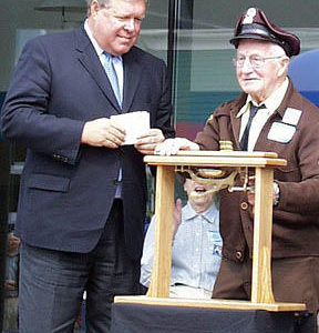 Cliff Fournier, 86, of Tenino, the last living trolley operator from the Tacoma Railway and Power Co., rings the bell that officially launches Tacoma Link light rail. To the left is U.S. Rep. Norm Dicks (D-6th District). (Photo by Brett Davis)