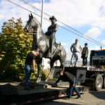 A monumental bronze statue of Theodore Roosevelt is loaded onto a flatbed trailer in preparation for a cross-country trek from Tacoma to Long Island, New York, and the tiny town of Oyster Bay, where Teddy Roosevelt was born. (PHOTO BY TODD MATTHEWS)