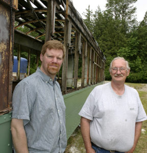 Vince and Tom Mendenhall, son-and-father owners of Arlington, Wash.-based Historic Railway Restoration, outside a 1908 Turtleback streetcar that once operated on Tacoma streets. (PHOTO BY TODD MATTHEWS)