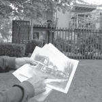 North Slope Historic District board chair Marshall McClintock compares a black-and-white photocopy of a row of 1900-era houses against what exits today: a 30-year-old apartment building. Before the neighborhood was designated a historic district, the old homes were razed to make way for the apartments. (PHOTO BY TODD MATTHEWS)