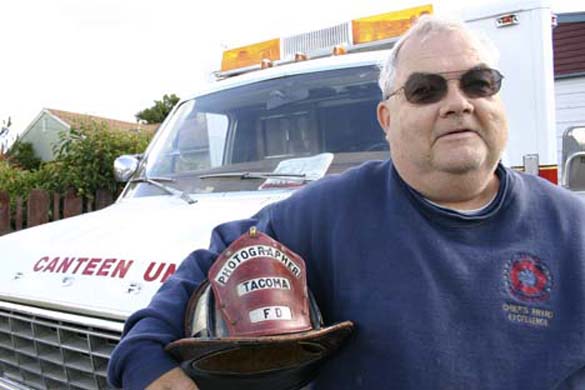 Tacoma resident Ralph Decker is one of several Fire Buffs who supports firefighters at emergency scenes. Decker and his wife, Michelle, serve food and water to firefighters and fire victims out of a mobile canteen unit. Decker has a long connection to the Tacoma Fire Department. He has served as the official photographer since 1971, and co-wrote a history of the department. (PHOTO BY TODD MATTHEWS)