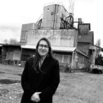 An improved historic preservation program in Pierce County could help Midland community activist Stacy Emerson, who stands in front of a former feed terminal, one of several old buildings slated for demolition. For two years, Emerson has tried to get her own 1918 building, the oldest commercial property in Midland, on Pierce County's historic register. (PHOTO BY TODD MATTHEWS)