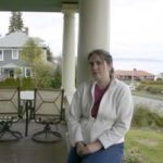 Architectural historian Caroline T. Swope on the porch of her 100-year-old Colonial Revival home in Tacoma's North End. The home has played an important role in Tacoma history. (PHOTO BY TODD MATTHEWS)