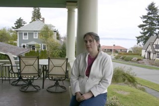 Architectural historian Caroline T. Swope on the porch of her 100-year-old Colonial Revival home in Tacoma's North End. The home has played an important role in Tacoma history. (PHOTO BY TODD MATTHEWS)