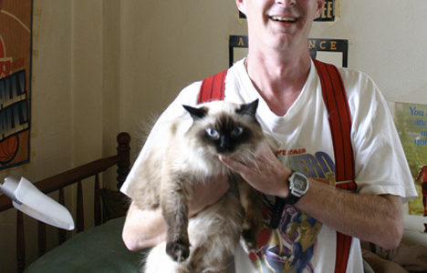 "It was kind of like my fate to live here," says Winthrop resident David Miller with a laugh. "Maybe when I die, I'll be a ghost in the hallways." Miller shares a studio on the eighth floor of the former historic hotel in downtown Tacoma with his cat 'Little Bit.' (PHOTO BY TODD MATTHEWS)