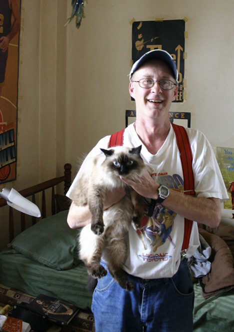 "It was kind of like my fate to live here," says Winthrop resident David Miller with a laugh. "Maybe when I die, I'll be a ghost in the hallways." Miller shares a studio on the eighth floor of the former historic hotel in downtown Tacoma with his cat 'Little Bit.' (PHOTO BY TODD MATTHEWS)