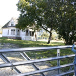 Architectural historian Susan Johnson photographs a former farmhouse outside Sumner. (PHOTO BY TODD MATTHEWS)