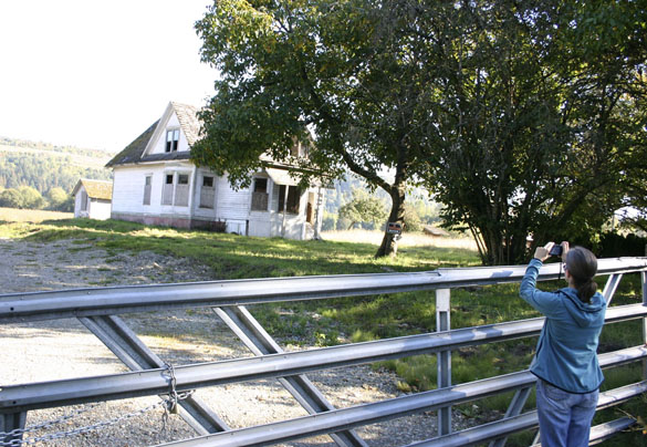 Architectural historian Susan Johnson photographs a former farmhouse outside Sumner. (PHOTO BY TODD MATTHEWS)