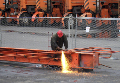 A worker separates pieces of a straddle carrier leg. (PHOTO COURTESY PORT OF TACOMA)
