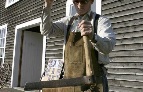 Steilacoom Historical Museum Association member member Buzz Brake demonstrates how to split cedar bolts. The museum received a grant from Pierce County to repair the roof and windows on the 1870s Nathaniel Orr wagon shop. (PHOTO BY TODD MATTHEWS)