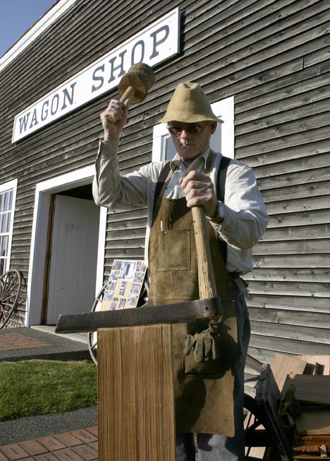Steilacoom Historical Museum Association member member Buzz Brake demonstrates how to split cedar bolts. The museum received a grant from Pierce County to repair the roof and windows on the 1870s Nathaniel Orr wagon shop. (PHOTO BY TODD MATTHEWS)