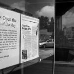 A sign in an empty storefront along Main Street in Buckley encourages grass roots support for re-opening the century-old Bank of Buckley. (PHOTO BY TODD MATTHEWS)