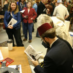 R. R. Anderson signs copies of his book of political cartoons at King's Books in Tacoma. (PHOTO BY TODD MATTHEWS)