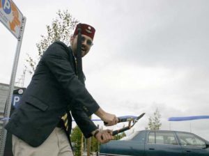 Tacoma political cartoonist R. R. Anderson marks the completion of the Sauro's parking lot downtown by holding a tongue-in-cheek ribbon-cutting ceremony. (PHOTO BY TODD MATTHEWS)