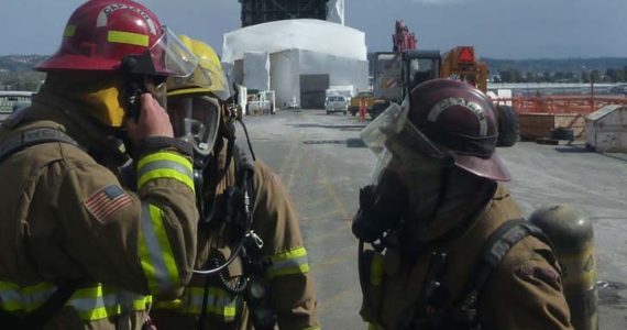 Tacoma firefighters responded Sunday at 11:45 a.m. to a report of hazardous condition on the Murray Morgan Bridge. First arriving firefighters found that the protective plastic sheathing surrounding one of the towers on the bridge had failed and a large volume of particulate matter was being blown from the scene. (PHOTO COURTESY TACOMA FIRE DEPARTMENT)