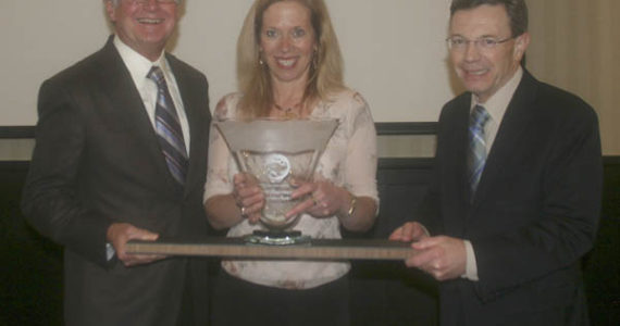 Tom Taylor (left) and Steve Thomason (right) of Taylor-Thomason Insurance Brokers present the Tacoma-Pierce County Chamber's Tahoma Environmental Award to Elaine Ott (center) of Richlite Company. (PHOTO COURTESY TACOMA-PIERCE COUNTY CHAMBER)