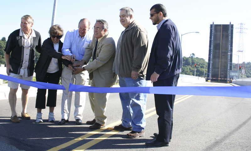 Representatives from the City of Tacoma and the Port of Tacoma celebrated the official re-opening of the Hylebos Bridge during a ribbon-cutting ceremony Wednesday. The bridge was out of commission for more than a decade before funding from the City of Tacoma, the Federal Highway Administration, and the Port of Tacoma paid for repairs. The Hylebos Bridge, which spans the Hylebos Waterway on East 11th Street, is an important transportation corridor for truck drivers hauling cargo throughout the tide flats and Northeast Tacoma residents headed toward State Route 509. (PHOTO BY TODD MATTHEWS)
