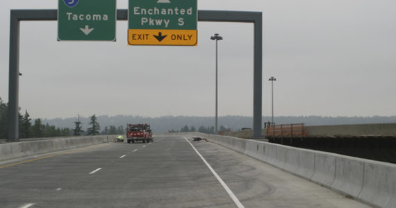 A contractor puts finishing touches on the first of two fly over ramps between Interstate 5 and State Route 18 in Federal Way.