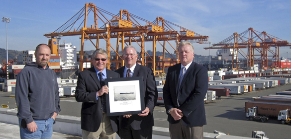 International Longshore and Warehouse Union (ILWU) Local 23 President Scott Mason (second from left) presented NYK Line (North America) President Bill Payne (second from right) with a historical photo of the ship's first visit. (PHOTO COURTESY PORT OF TACOMA)