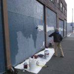 An artist works on the new mural in downtown Tacoma. (PHOTO COURTESY DOWNTOWN ON THE GO)