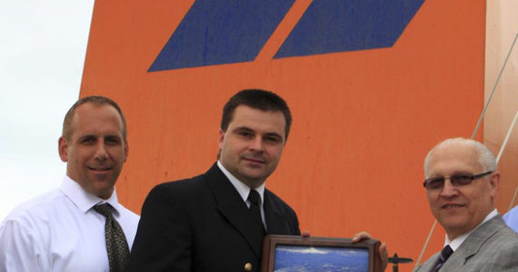 In July, Port of Tacoma Commissioner Don Johnson (far right) and Port CEO John Wolfe (far left) presented Hapag-Lloyd's Dusseldorf Express Captain Detlef Rose (center) with a plaque to commemorate the vessel's first call to Tacoma. (PHOTO COURTESY PORT OF TACOMA)