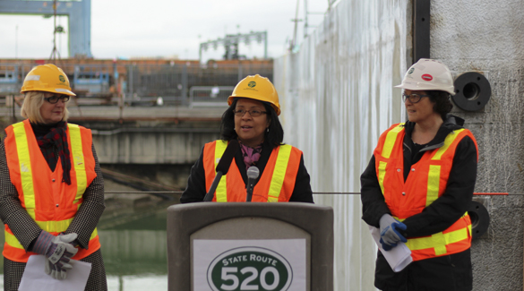Tacoma Mayor Marilyn Strickland (center) speaks during the float-out event held on Monday at the Concrete Technology Corp. site in Tacoma. She was joined by Pierce County Executive Pat McCarthy (left) and Washington State Department of Transportation Secretary Paula Hammond (right). (PHOTO COURTESY WASHINGTON STATE DEPARTMENT OF TRANSPORTATION)