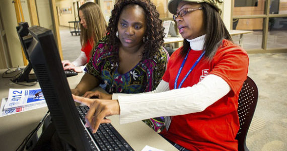 Volunteer tax preparer Jamika Hilliard, right, goes over some numbers while preparing the taxes of Christina Young, left,  of Tacoma, during the annual KeyBank Super Refund Saturday, hosted by Goodwill's VITA program at the Milgard Work Opportunity Center in Tacoma. Super Refund Saturday is a one-day event during which community volunteers and banking professionals provide free income tax preparation assistance to low- and moderate-income wage earners and help them identify their eligibility for the Earned Income Tax Credit. (PHOTO BY DAN DELONG / COURTESY TACOMA GOODWILL)