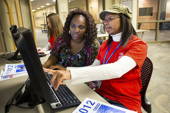 Volunteer tax preparer Jamika Hilliard, right, goes over some numbers while preparing the taxes of Christina Young, left,  of Tacoma, during the annual KeyBank Super Refund Saturday, hosted by Goodwill's VITA program at the Milgard Work Opportunity Center in Tacoma. Super Refund Saturday is a one-day event during which community volunteers and banking professionals provide free income tax preparation assistance to low- and moderate-income wage earners and help them identify their eligibility for the Earned Income Tax Credit. (PHOTO BY DAN DELONG / COURTESY TACOMA GOODWILL)