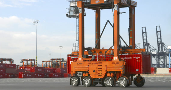 A straddle carrier moves a "K" Line cargo container at the Port of Tacoma's Husky Terminal. (PHOTO COURTESY PORT OF TACOMA)