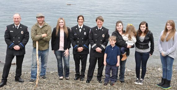 (from left to right) Tacoma fire fighter Jack Hawkins, John Bronson, Rebecca Thayer-Blunt, fire fighter Annie Craig, captain Jennifer Gunnel, and extended family at Owen Beach. (PHOTO COURTESY TACOMA FIRE DEPARTMENT)