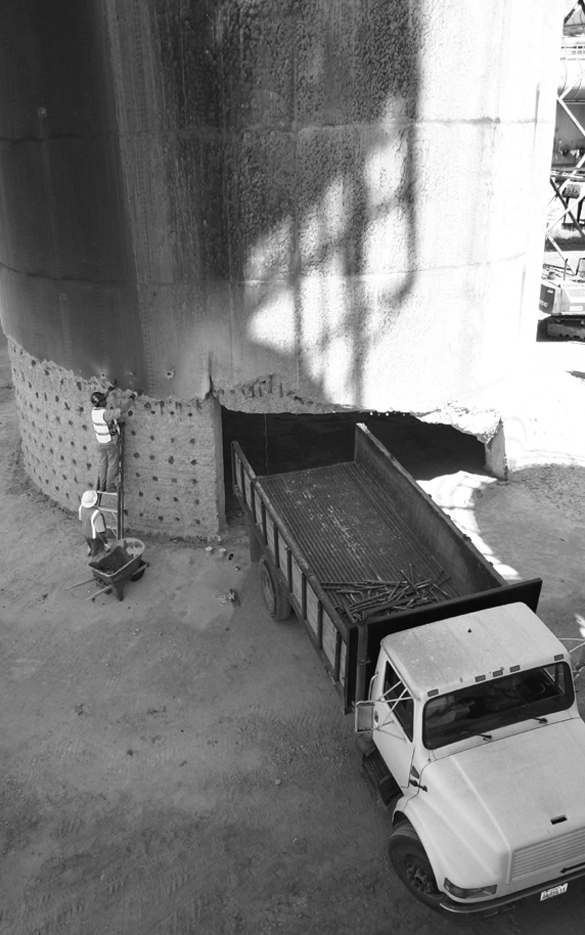 Darrell Ogden loads explosives into the base of a smokestack on the former Kaiser Aluminum site on the Port of Tacoma tide flats. The 500-foot tower was demolished on July 2, 2006, to make room for future growth at the port. (FILE PHOTO BY TODD MATTHEWS)