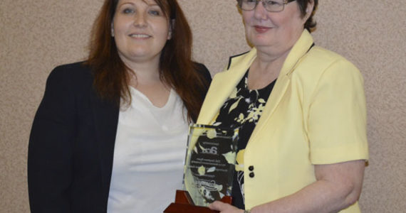 Amy Tiemeyer (left), Military Relations Liaison at America's Credit Union presented this year's Howard O. Scott Citizen-Soldier of the Year Award to Cathy Ryan on behalf of her husband, Washington Army National Guard Staff Sergeant Stephen Ryan, who was on temporary duty assignment. (PHOTO COURTESY TACOMA-PIERCE COUNTY CHAMBER)