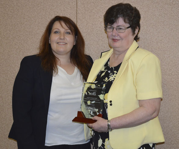 Amy Tiemeyer (left), Military Relations Liaison at America's Credit Union presented this year's Howard O. Scott Citizen-Soldier of the Year Award to Cathy Ryan on behalf of her husband, Washington Army National Guard Staff Sergeant Stephen Ryan, who was on temporary duty assignment. (PHOTO COURTESY TACOMA-PIERCE COUNTY CHAMBER)