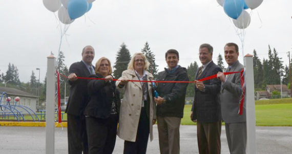 Pierce County Councilmember Rick Talbert (far left), Pierce County Council Chair Joyce McDonald (second from left), and Pierce County Executive Pat McCarthy (third from left) marked the completion of a series of road projects that spanned nearly five miles and 20 years during a ribbon-cutting ceremony later this month. (PHOTO COURTESY PIERCE COUNTY)