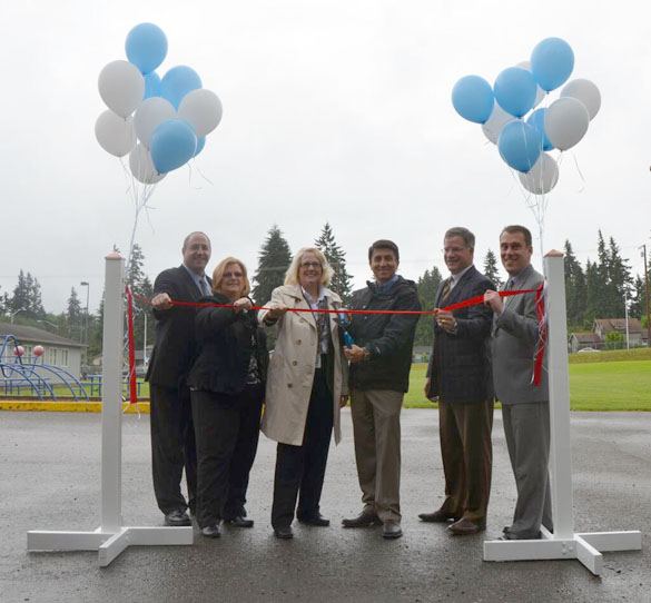 Pierce County Councilmember Rick Talbert (far left), Pierce County Council Chair Joyce McDonald (second from left), and Pierce County Executive Pat McCarthy (third from left) marked the completion of a series of road projects that spanned nearly five miles and 20 years during a ribbon-cutting ceremony later this month. (PHOTO COURTESY PIERCE COUNTY)