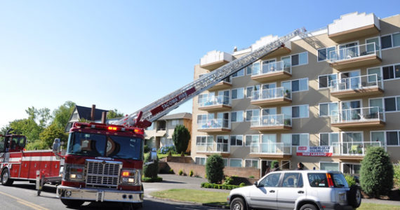 Tacoma Fire: Discarded cigarette sparks minor rooftop apartment building blaze