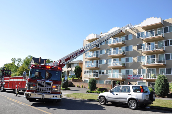 Tacoma Fire: Discarded cigarette sparks minor rooftop apartment building blaze