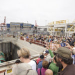 Guests at a public dedication ceremony Saturday try to get a glimpse of the machine as its five-story-tall cutterhead spins. (PHOTO COURTESY WSDOT)