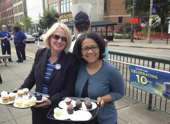 Pierce County Executive Pat McCarthy (left) and Tacoma Mayor Marilyn Strickland (right) greeted Link light rail riders at Union Station Thursday with free treats from Hello, Cupcake in downtown Tacoma.
