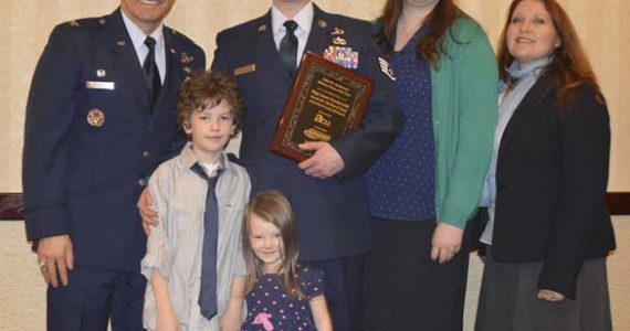 Colonel David Kumashiro (far left) and America’s Credit Union’s Military Relations Liaison (far right) presented the Tacoma-Pierce County Chamber's 35th Annual John H. Anderson Military Citizen of the Year Award to Staff Sergeant Jason Truskowski (center) on Wednesday. Truskowski was joined by his wife Kristin and their children. (PHOTO COURTESY TACOMA-PIERCE COUNTY CHAMBER)