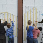 Students from Seabury Middle School volunteer on the creation of artist Diana Leigh Surma's "Show Your Stripes," a Market Street mural of abstract geometric shapes. (PHOTO COURTESY SPACEWORKS TACOMA)