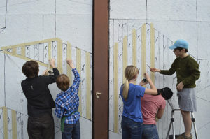 Students from Seabury Middle School volunteer on the creation of artist Diana Leigh Surma's "Show Your Stripes," a Market Street mural of abstract geometric shapes. (PHOTO COURTESY SPACEWORKS TACOMA)