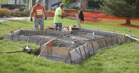 Contractors made final site preparations before concrete was poured Monday morning at the future home of Tacoma's Sun King sculpture. (PHOTO BY TODD MATTHEWS)