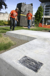 Contractors prepare to place a section of Tom Morandi's Sun King sculpture in a park near Thea Foss Waterway. (PHOTO BY TODD MATTHEWS)