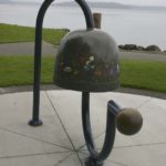 The City of Tacoma recently completed a project to restore the Children's Bell sculpture located along Ruston Way near the shores of Commencement Bay. The four-foot-tall bronze artwork was created in 2000 by artist Larry Anderson in order to celebrate the life, spirit, and accomplishments of Washington PAVE Founder and Director Marty Gentili, who passed away in 1993. The bell is decorated with images of children around the border and is meant to be rung by visitors. In April, area visitors noticed safety barricades were in place around the sculpture while the contractor spent several weeks completing restoration work on the Children's Bell sculpture. (PHOTO BY TODD MATTHEWS)