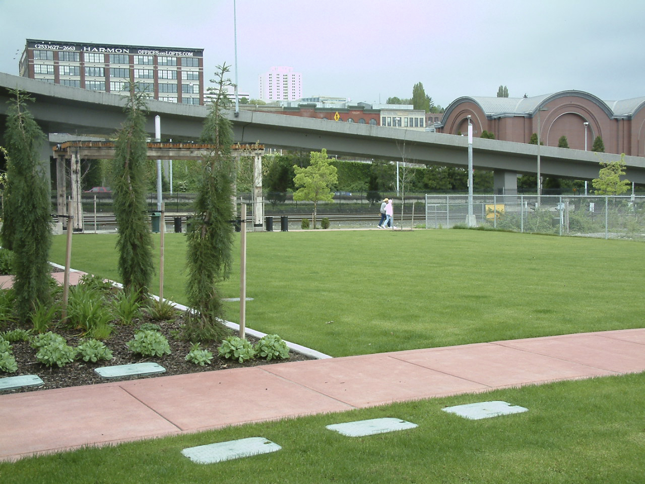 The City of Tacoma is requesting a $60,000 grant from the Washington State Recreation and Conservation Office to help pay for a children's play area at a City-owned park near South 21st Street and Dock Street. The eco-friendly play area would feature a LEED-certified mat surface and landscaping with native plants. It would also expand the diversity of use within the park and draw more visitors and activities to the area. The project is a partnership between the City of Tacoma, Foss Waterway Development Authority, and The Henry Group, a private developer currently constructing a 161-unit, $32 million apartment building nearby. (IMAGE COURTESY CITY OF TACOMA)