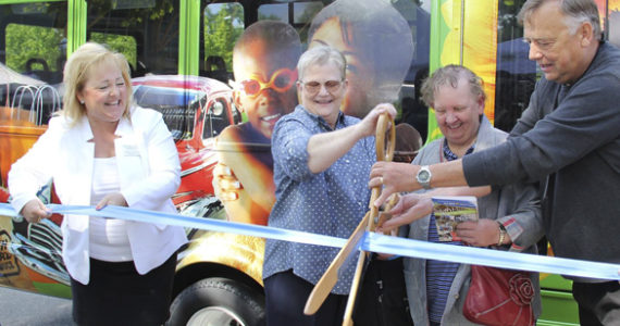 Puyallup Sumner Chamber of Commerce President and CEO Shelly Schlumpf, Pierce Transit CEO Lynne Griffith, an excited member of the public, and Pierce Transit Board Vice-Chair Steve Vermillion cut the ribbon on the new Puyallup Connector Route 425 at the Puyallup Farmers' Market last weekend. (PHOTO COURTESY PIERCE TRANSIT)