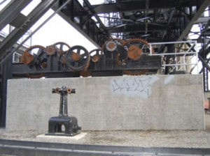 The concrete wall of the stormwater collection system below the western side of Tacoma's Murray Morgan Bridge before Gig Harbor artist Nick Goettling began to pain the mural. (PHOTO COURTESY CITY OF TACOMA)