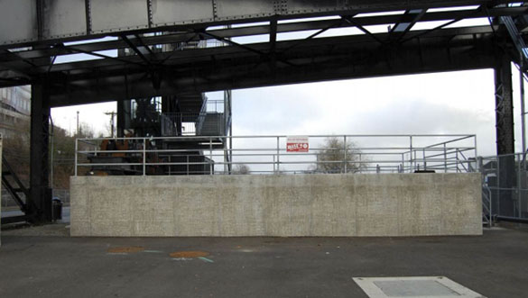 The concrete wall of the stormwater collection system below the western side of Tacoma's Murray Morgan Bridge before Gig Harbor artist Nick Goettling began to pain the mural. (PHOTO COURTESY CITY OF TACOMA)